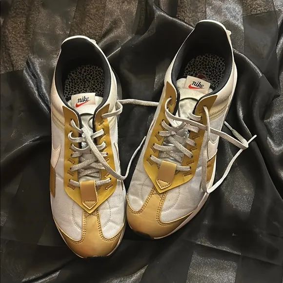 Nike White and Gold Sneakers with Iconic Swoosh