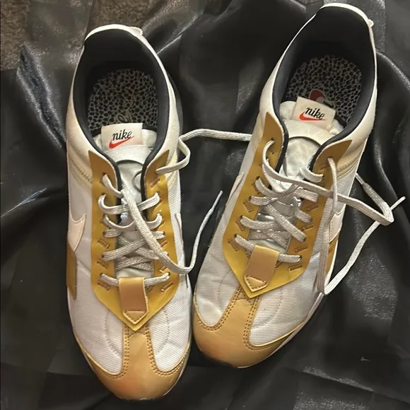 Nike White and Gold Sneakers with Iconic Swoosh